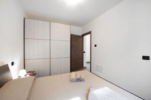 a bedroom with a bed with two slippers on it at Appartamento 5 Il Tornante in Nesso +20 photos