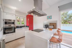 a kitchen with white cabinets and a counter top at Villa Bahia Azul in Llucmajor
