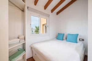 a bedroom with a bed and a window at Villa Bahia Azul in Llucmajor +19 photos