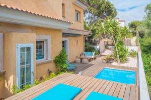 a villa with a swimming pool and a house at Villa Bahia Azul in Llucmajor