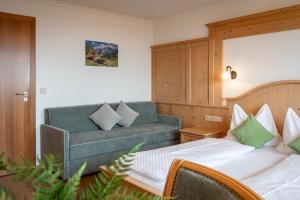a living room with two beds and a couch at Residence Diana Apartment 202 in Terento
