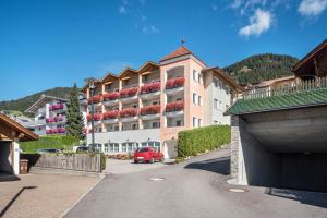 a building with a red car parked in front of it at Residence Diana Apartment 202 in Terento