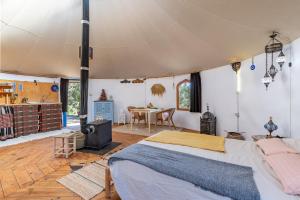 a bedroom with a large bed in a tent at Eco Yurta Lanjarón in Lanjarón