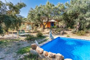 an outdoor swimming pool in a yard with a house at Eco Yurta Lanjarón in Lanjarón +24 photos