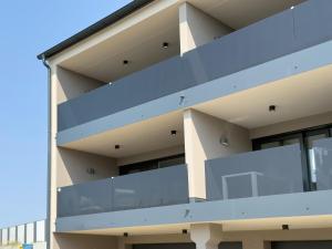 a facade of a building with blue balconies at Herzensprojekt in Pfullendorf