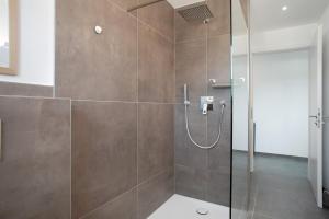 a bathroom with a shower with a glass door at Herzensprojekt in Pfullendorf +13 photos