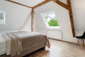 a bedroom with a bed and a window at Apartment mit Jacuzzi Enschede 10km in Gronau