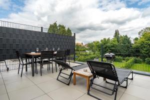 a patio with a table and chairs on a balcony at Apartment mit Jacuzzi Enschede 10km in Gronau