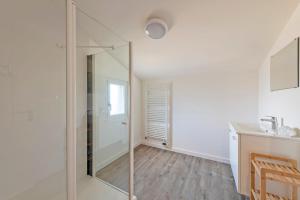 a bathroom with a glass shower and a sink at À la maison de Goulannou in Tréflez +26 photos