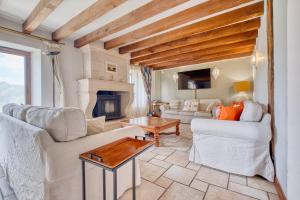 a living room with two couches and a fireplace at La Maison Roudier in Razac-dʼEymet