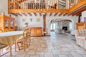 a large living room with a table and chairs at La Maison Roudier in Razac-dʼEymet