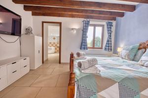 a bedroom with a large bed and a tv at La Maison Roudier in Razac-dʼEymet +23 photos
