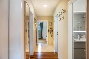 a hallway of a home with a sink and a mirror at Ferienwohnung Pfingstrose in Garmisch-Partenkirchen +25 photos