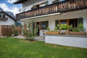 a house with a patio with plants on it at Ferienwohnung Pfingstrose in Garmisch-Partenkirchen