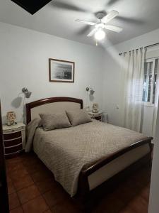 a bedroom with a bed and a ceiling fan at Poniente in Roche +18 photos
