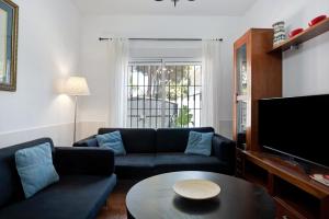 a living room with a couch and a table at Poniente in Roche