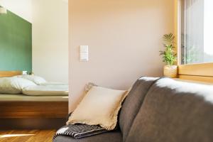 a bedroom with a bed and a couch with a pillow at Ferienwohnung Elfriede in Neukirch