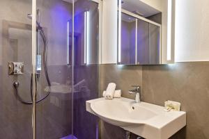 a bathroom with a sink and a shower at Kamerloy Apartments B in Campitello di Fassa +21 photos