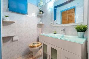 a bathroom with a toilet and a sink and a mirror at Loft Sf5 in L'Ametlla de Mar
