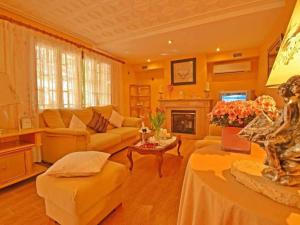 a living room with a couch and a fireplace at Benestar in El Toro