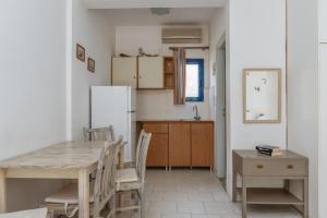 a kitchen with a table and a refrigerator at Perasma Studios 10 in Kipri