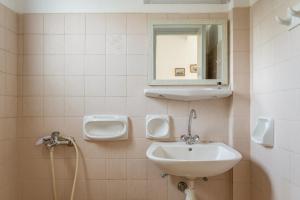 a bathroom with a sink and a mirror at Perasma Studios 10 in Kipri