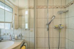 a bathroom with a shower and a sink at Ferienwohnung Lilo in Immenstaad am Bodensee +15 photos