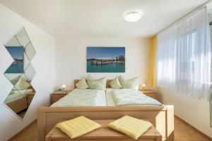 a bedroom with a bed and a large window at Ferienwohnung Lilo in Immenstaad am Bodensee