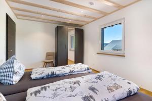a bedroom with two beds and a window at Kapellenhof Ferienwohnungen in Triberg