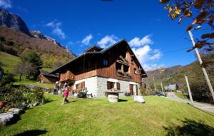 a man standing in front of a house at Chalet Arclosan - Saint-Ferréol in Saint-Ferréol