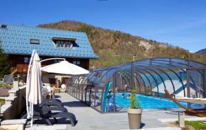 a resort with a swimming pool and a building at Chalet Arclosan - Saint-Ferréol in Saint-Ferréol