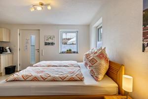 a bedroom with a bed and two pillows on it at Ferienwohnung Alpenblick in Zwiefalten