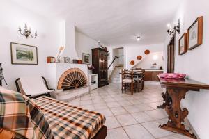 a living room with a fireplace and a table at Villa Margherita in Marongiu