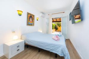 a small bedroom with a bed and a tv at Can Juanito in Alcudia