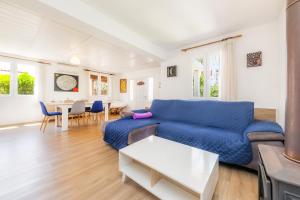 a living room with a blue couch and a table at Can Juanito in Alcudia