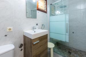 a bathroom with a sink and a glass shower at Can Juanito in Alcudia +19 photos