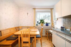 a kitchen and dining room with a table and chairs at Ferienwohnung Schwenck in Kressbronn am Bodensee