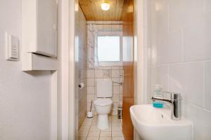 a small bathroom with a toilet and a sink at Ferienwohnung Schwenck in Kressbronn am Bodensee