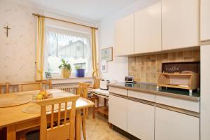 a kitchen with a table and a dining room at Ferienwohnung Schwenck in Kressbronn am Bodensee +11 photos