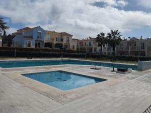 a large swimming pool in front of some houses at Vista Hermosa in Ayamonte