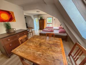 a room with two beds and a wooden table at Wohnung 3 in Burghaslach