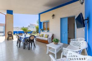 a living room with a couch and a table and chairs at Villa Lindarelax in Santa Maria del Focallo
