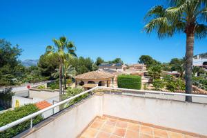 a view from the balcony of a house with a palm tree at Casa Colina in Albir