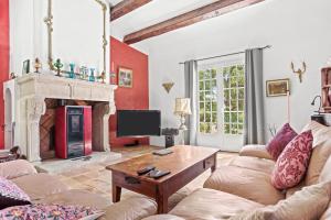 a living room with a couch and a fireplace at Bastide Lou Pèbre D’aï in La Roquebrussanne