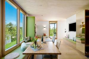 a dining room with a table and a large window at Bodensee Oberschwaben in Horgenzell