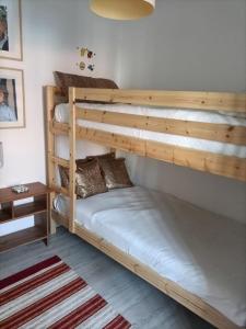 a bedroom with two bunk beds and a table at Akademia House - Santarém in Santarém