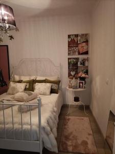 a bedroom with a white bed and a table at Akademia House - Santarém in Santarém +6 photos