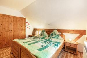 a bedroom with a large bed in a room at Ferienhaus 'am Aartalsee' in Ahrdt