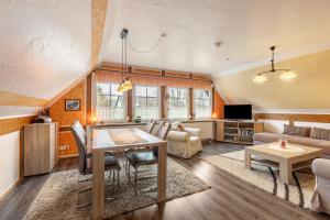a living room with a table and a couch at Ferienhaus 'am Aartalsee' in Ahrdt