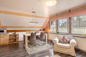 a kitchen and living room with a table and chairs at Ferienhaus 'am Aartalsee' in Ahrdt